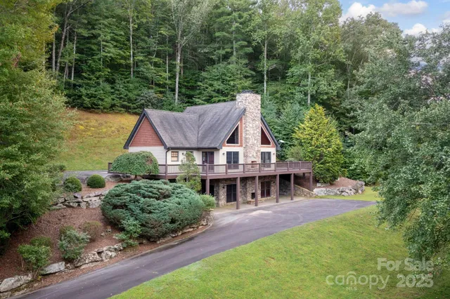 an aerial view of a house with swimming pool and garden