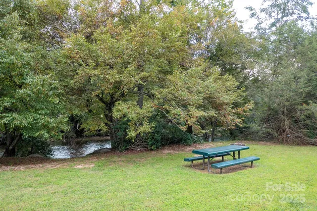 a view of a backyard with a bench