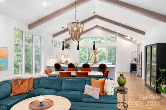 a living room with fireplace furniture and a floor to ceiling window