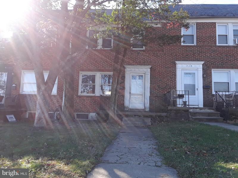 726 Braeside Road Baltimore, MD 21229 - Photo 1 of 15 a view of a brick house next to a yard