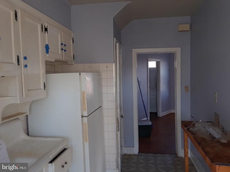 726 Braeside Road Baltimore, MD 21229 - Photo 2 of 15 a kitchen with a refrigerator and cabinets