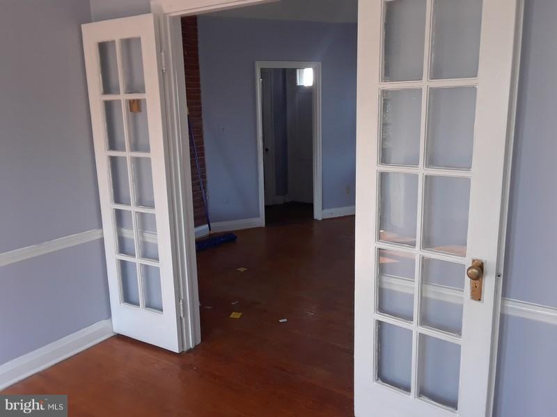 726 Braeside Road Baltimore, MD 21229 - Photo 5 of 15 a view of an empty room with wooden floor and closet