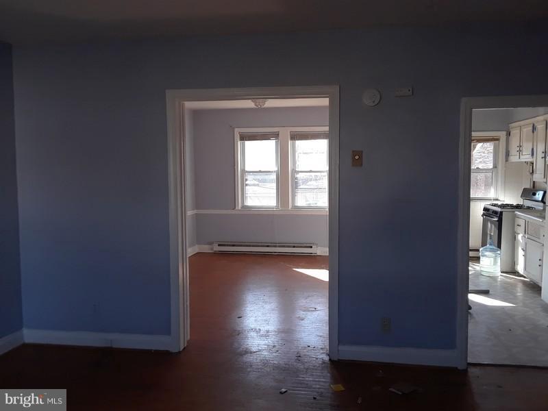 726 Braeside Road Baltimore, MD 21229 - Photo 7 of 15 a view of a room with wooden floor and a window