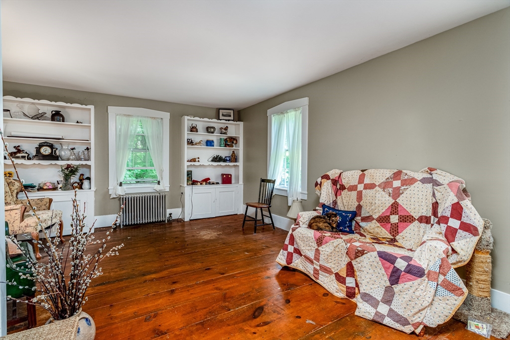16 Maple Street Sterling, MA 01564 - Photo 21 of 42 a bedroom with furniture and a book shelf