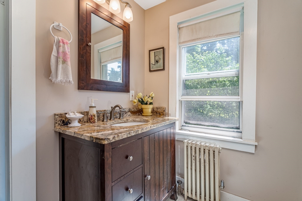 16 Maple Street Sterling, MA 01564 - Photo 33 of 42 a bathroom with a granite countertop sink and a mirror