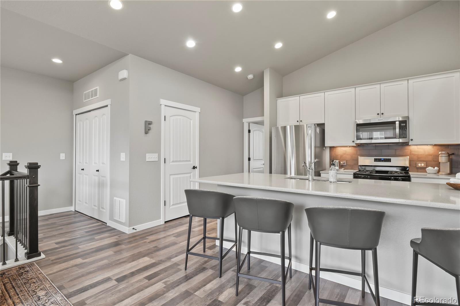 1344 Sunshine Valley Way Colorado Springs, CO 80921 - Photo 14 of 37 a kitchen with stainless steel appliances granite countertop a table chairs sink and cabinets