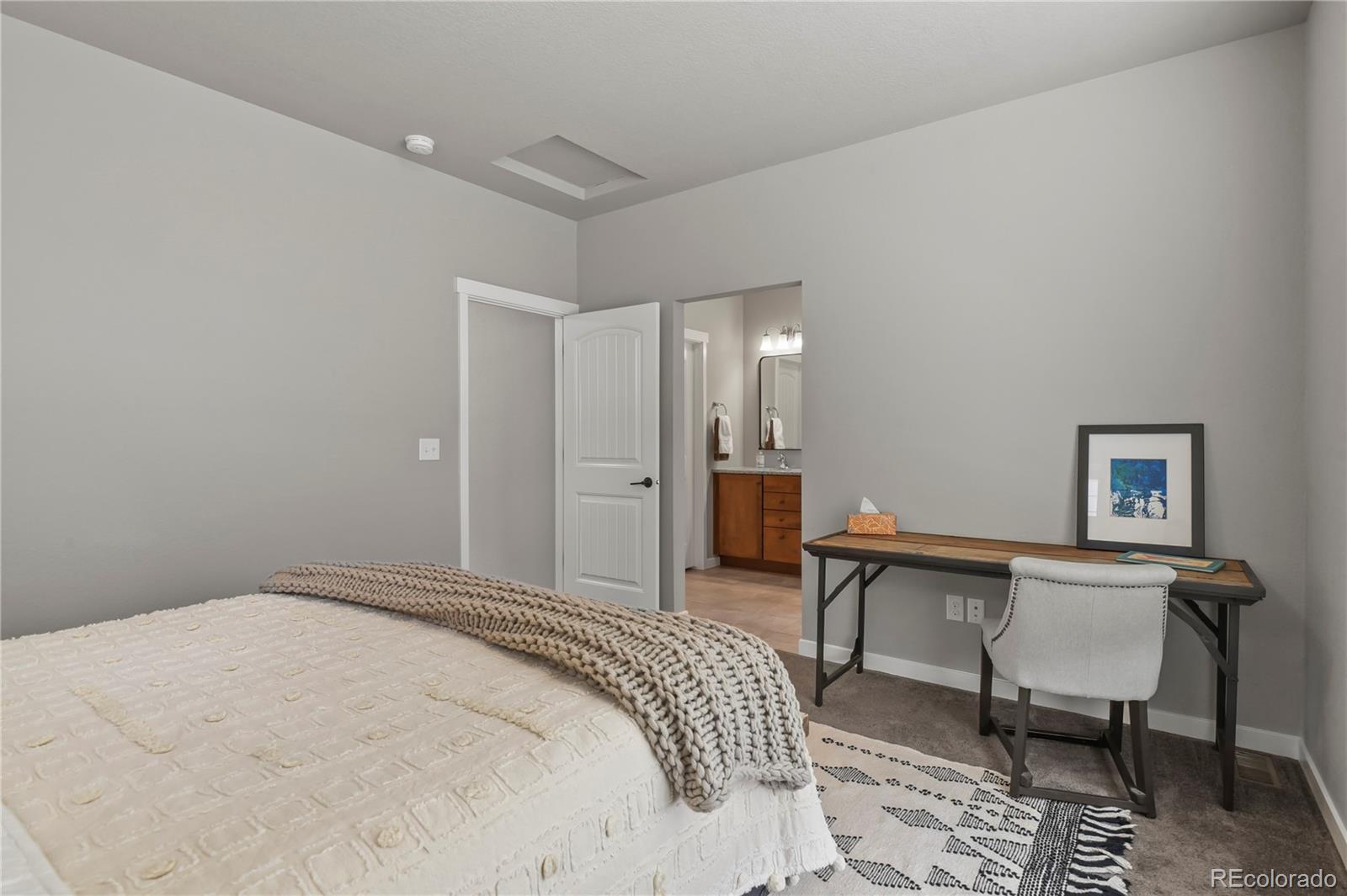 1344 Sunshine Valley Way Colorado Springs, CO 80921 - Photo 20 of 37 a bedroom with a bed and a table
