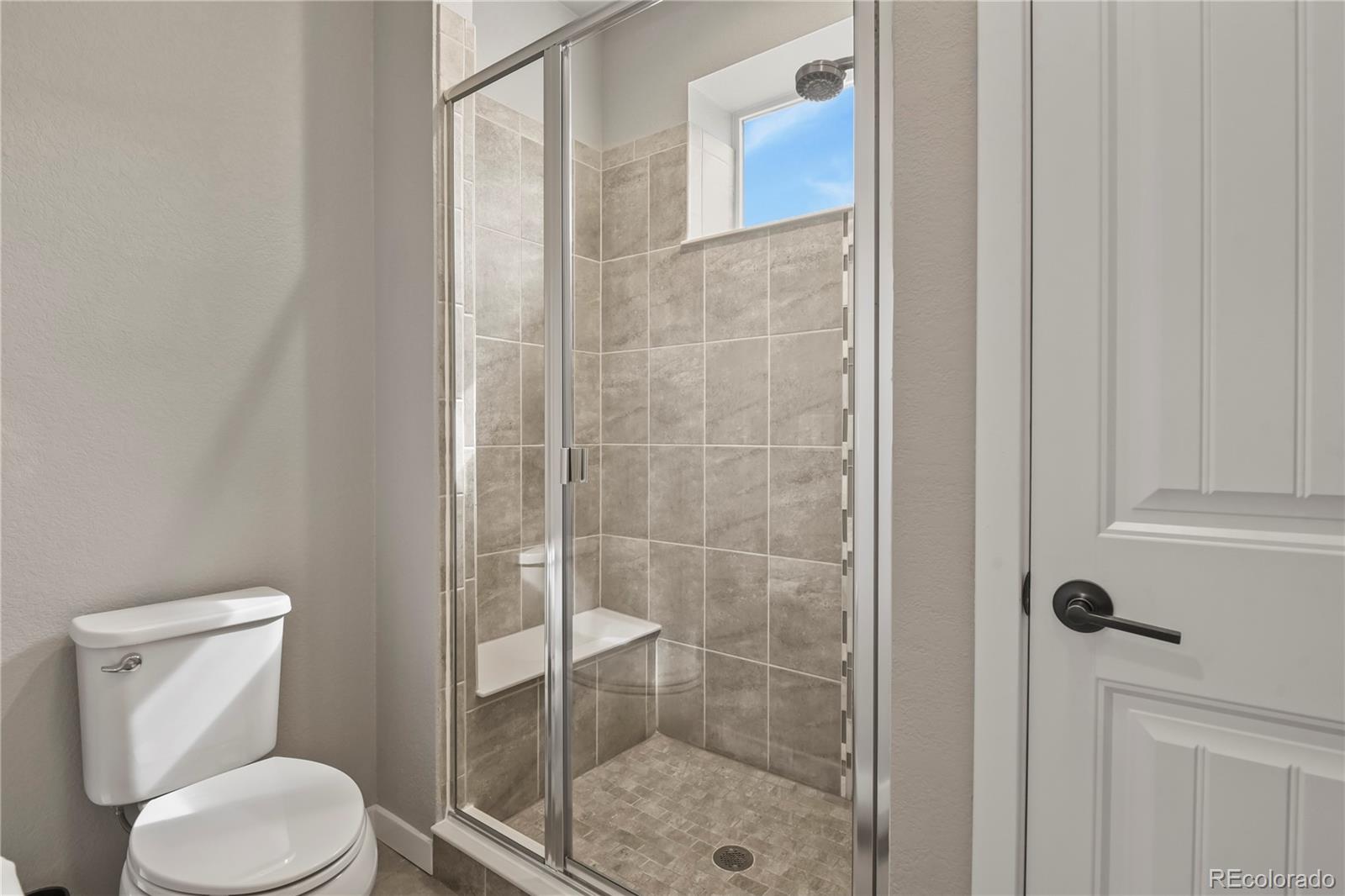 1344 Sunshine Valley Way Colorado Springs, CO 80921 - Photo 23 of 37 a bathroom with a toilet and a shower