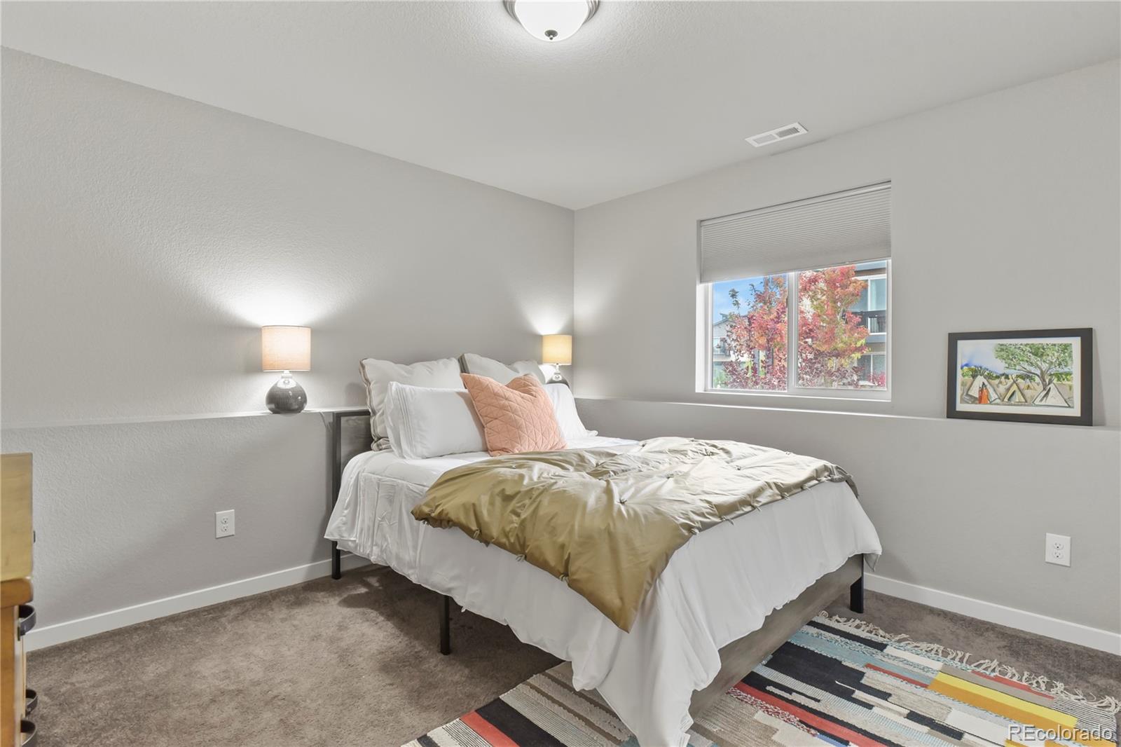 1344 Sunshine Valley Way Colorado Springs, CO 80921 - Photo 28 of 37 a bedroom with bed and a window