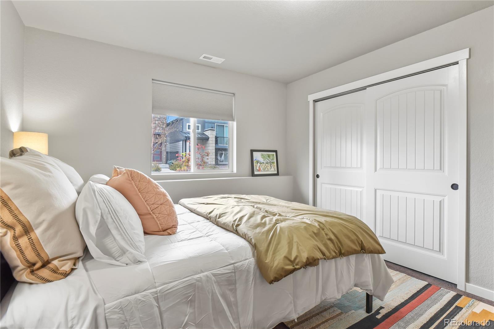 1344 Sunshine Valley Way Colorado Springs, CO 80921 - Photo 29 of 37 a bedroom with a bed and wooden floor
