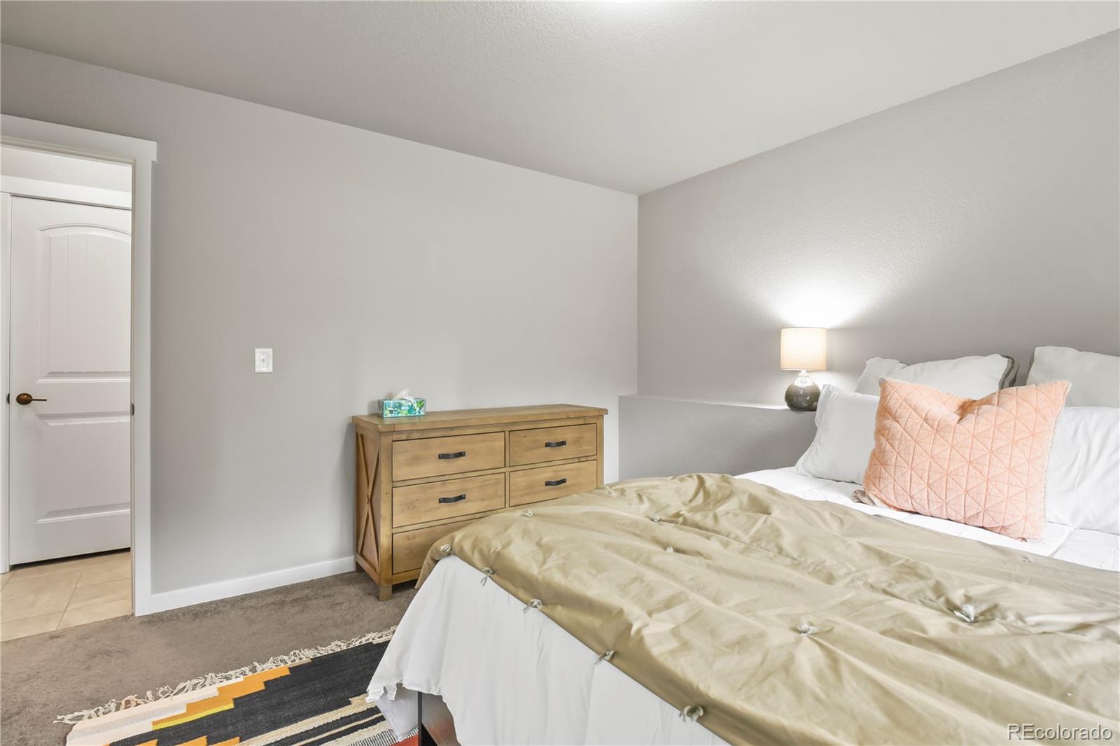 1344 Sunshine Valley Way Colorado Springs, CO 80921 - Photo 30 of 37 a bedroom with a bed and a dresser