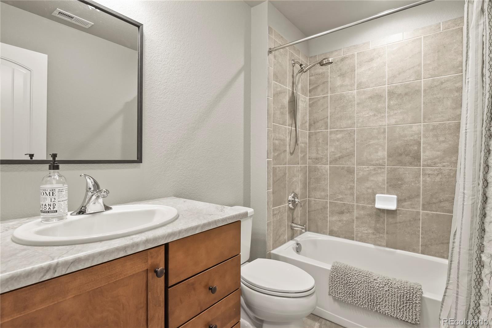 1344 Sunshine Valley Way Colorado Springs, CO 80921 - Photo 31 of 37 a bathroom with a sink toilet and shower