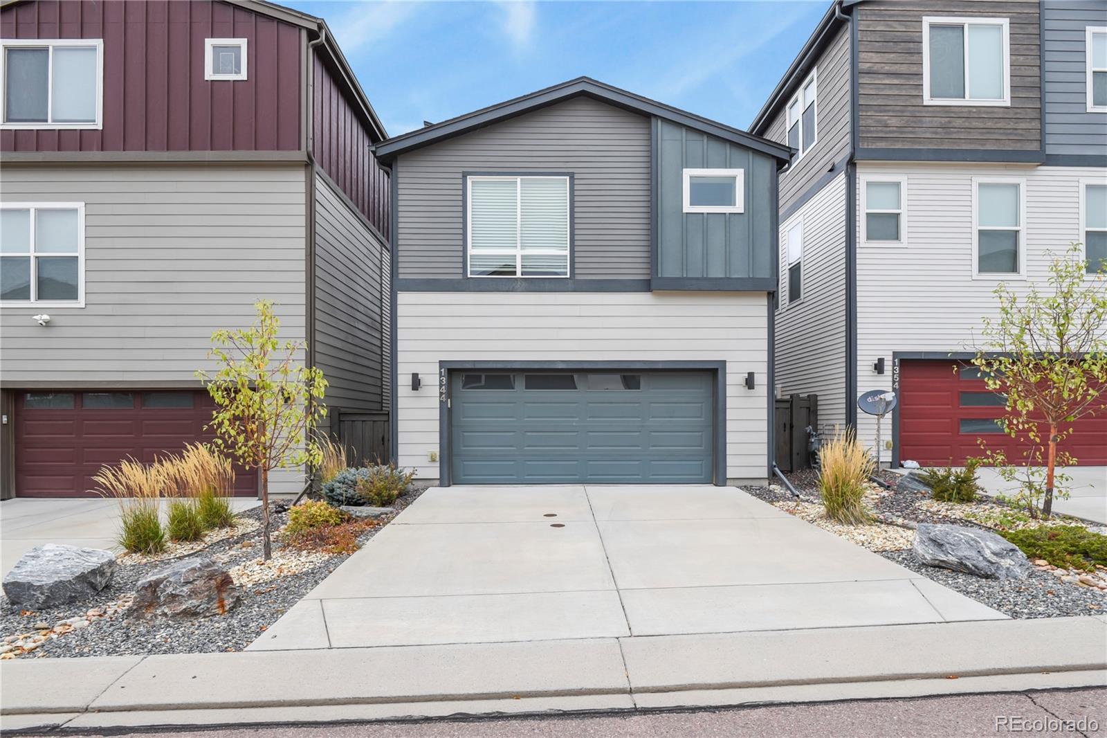 1344 Sunshine Valley Way Colorado Springs, CO 80921 - Photo 35 of 37 a front view of a house with garage and plants