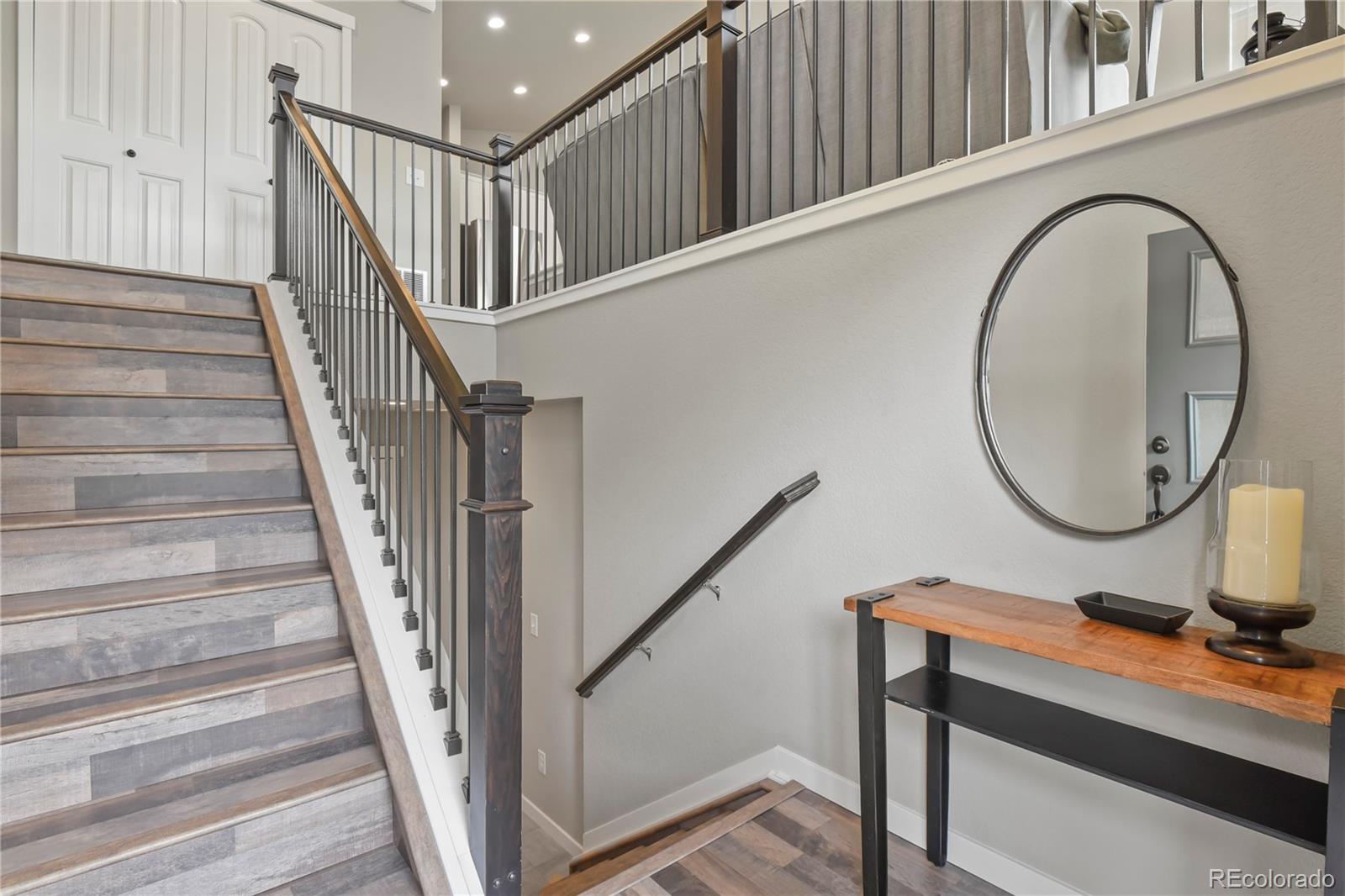 1344 Sunshine Valley Way Colorado Springs, CO 80921 - Photo 5 of 37 a view of a hallway with wooden floor and white walls