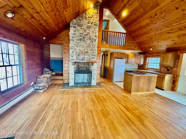 a kitchen with stainless steel appliances granite countertop a refrigerator a stove and a wooden cabinets