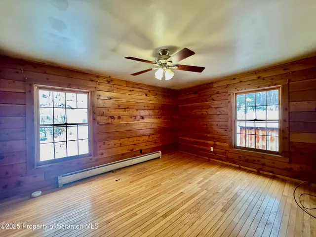 wooden floor in an empty room with a window