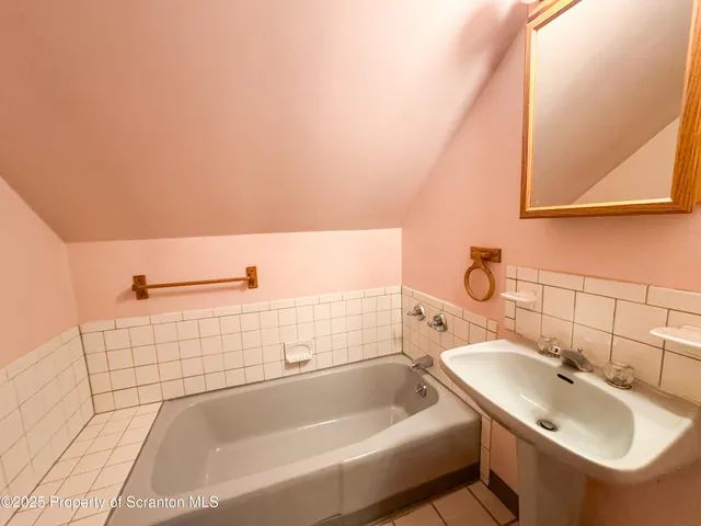 a bathroom with a sink a toilet and bathtub