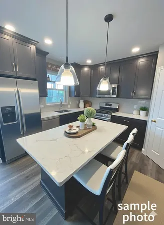 a large kitchen with a table chairs and a refrigerator