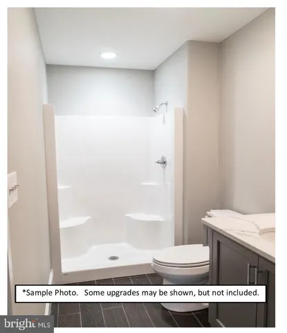 a bathroom with a sink toilet and a mirror