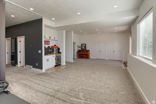 828 South Deer Road Tooele, UT 84074 - Photo 21 of 51 Lower-level recreation space featuring recessed lighting and neutral carpeting