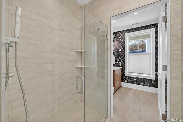 a bathroom with a glass shower door
