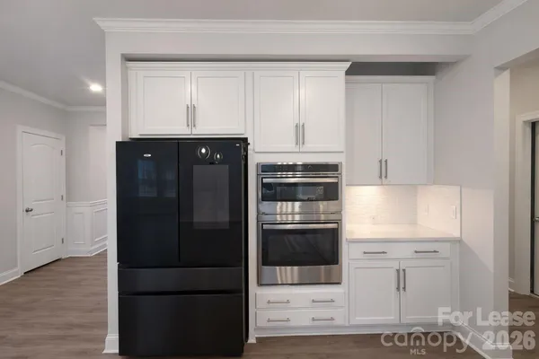 a kitchen with stainless steel appliances kitchen island granite countertop a refrigerator and a stove
