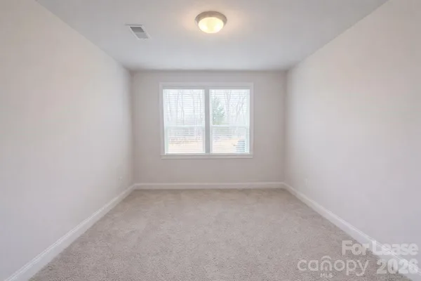 a view of room with a ceiling fan and window