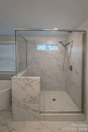 a white toilet sitting next to a shower