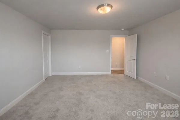a bathroom with a granite countertop toilet a sink and a mirror