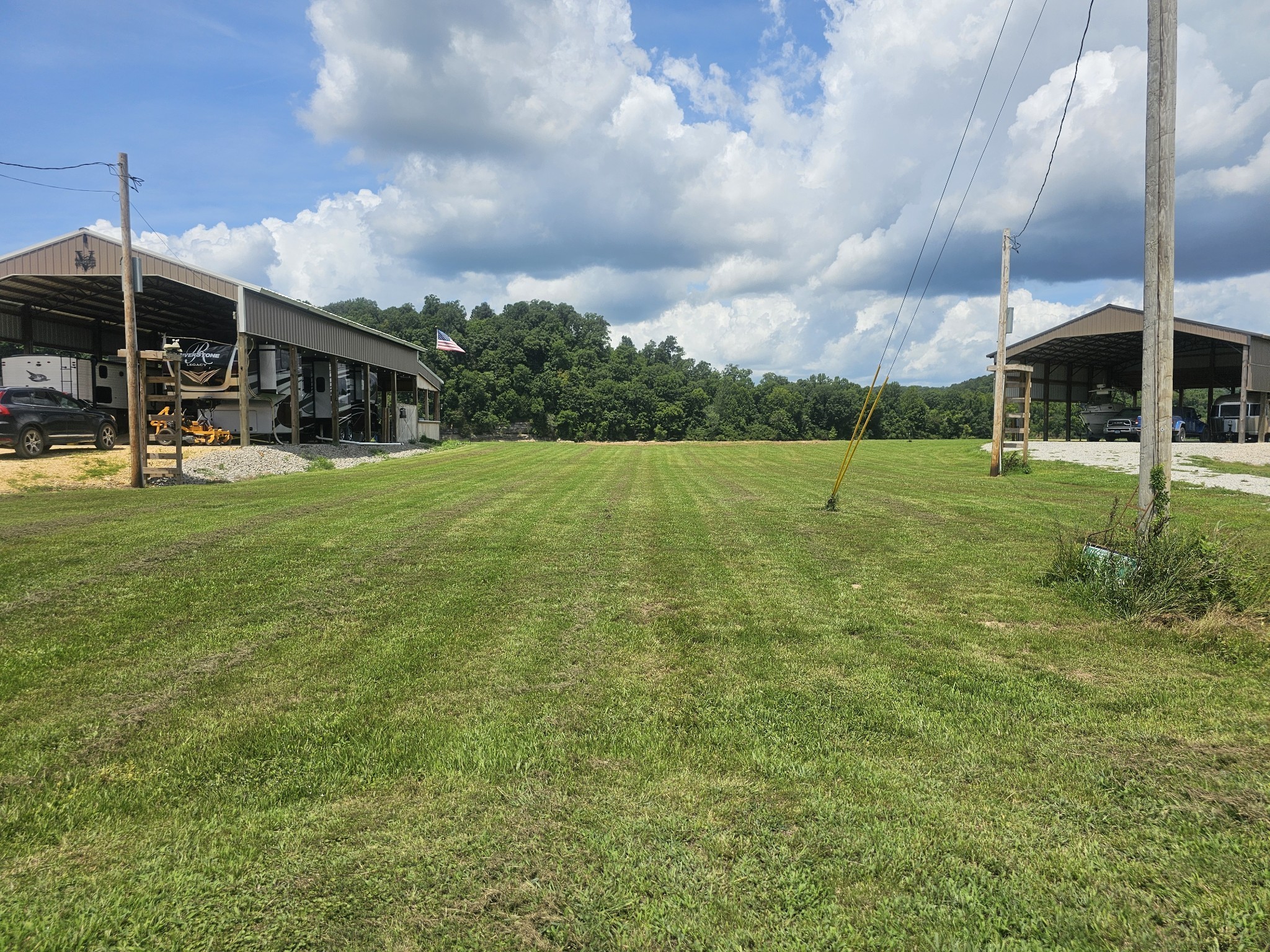 2271 Hardin Bottom River Road Clifton, TN 38425 - Photo 2 of 21 a view of a big yard with a house in the background