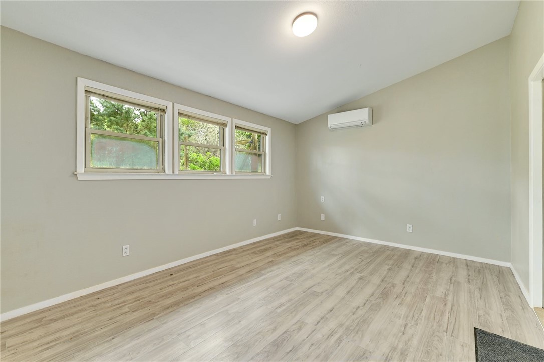901 Valley View Drive Austin, TX 78733 - Photo 19 of 25 an empty room with wooden floor and windows