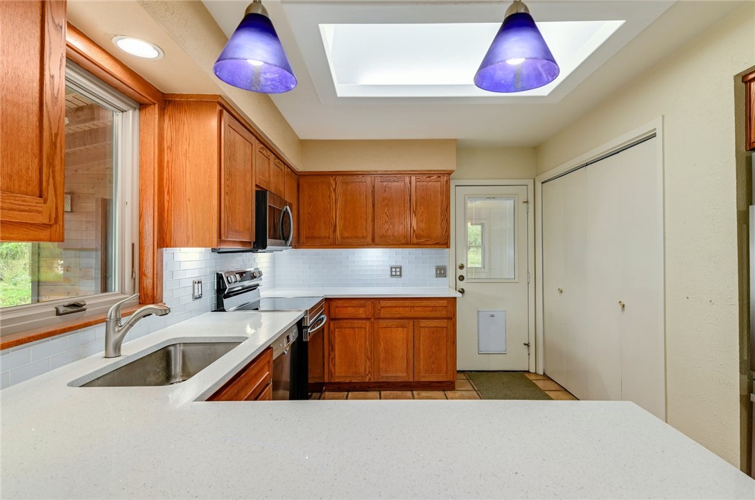 901 Valley View Drive Austin, TX 78733 - Photo 8 of 25 a kitchen with a sink a counter space and cabinets