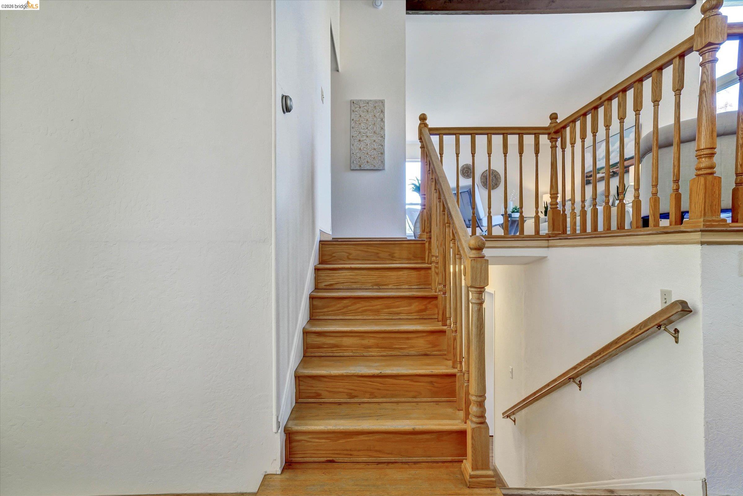 2826 Wright Avenue Pinole, CA 94564 - Photo 33 of 70 Natural wood staircase with matching wood balusters and handrails, complemented by white painted walls