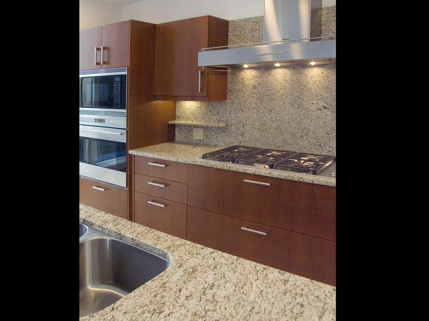 Undisclosed Address Chicago, IL 60611 - Photo 6 of 15 a kitchen with granite countertop a sink and a stove