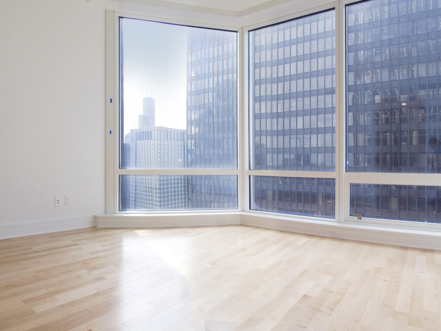 Undisclosed Address Chicago, IL 60611 - Photo 8 of 15 a view of an empty room with wooden floor and a window
