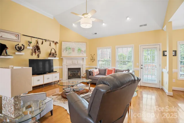 a living room with furniture a large window and a fireplace