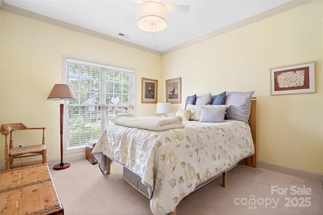 a spacious bedroom with a bed and a lamp