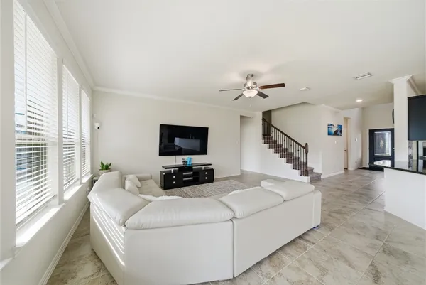 a living room with furniture and a dining table with kitchen view