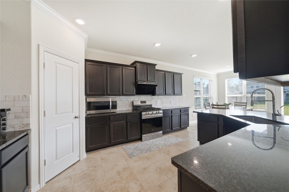 4335 Tawny Timber Drive Spring, TX 77386 - Photo 12 of 42 a large kitchen with cabinets