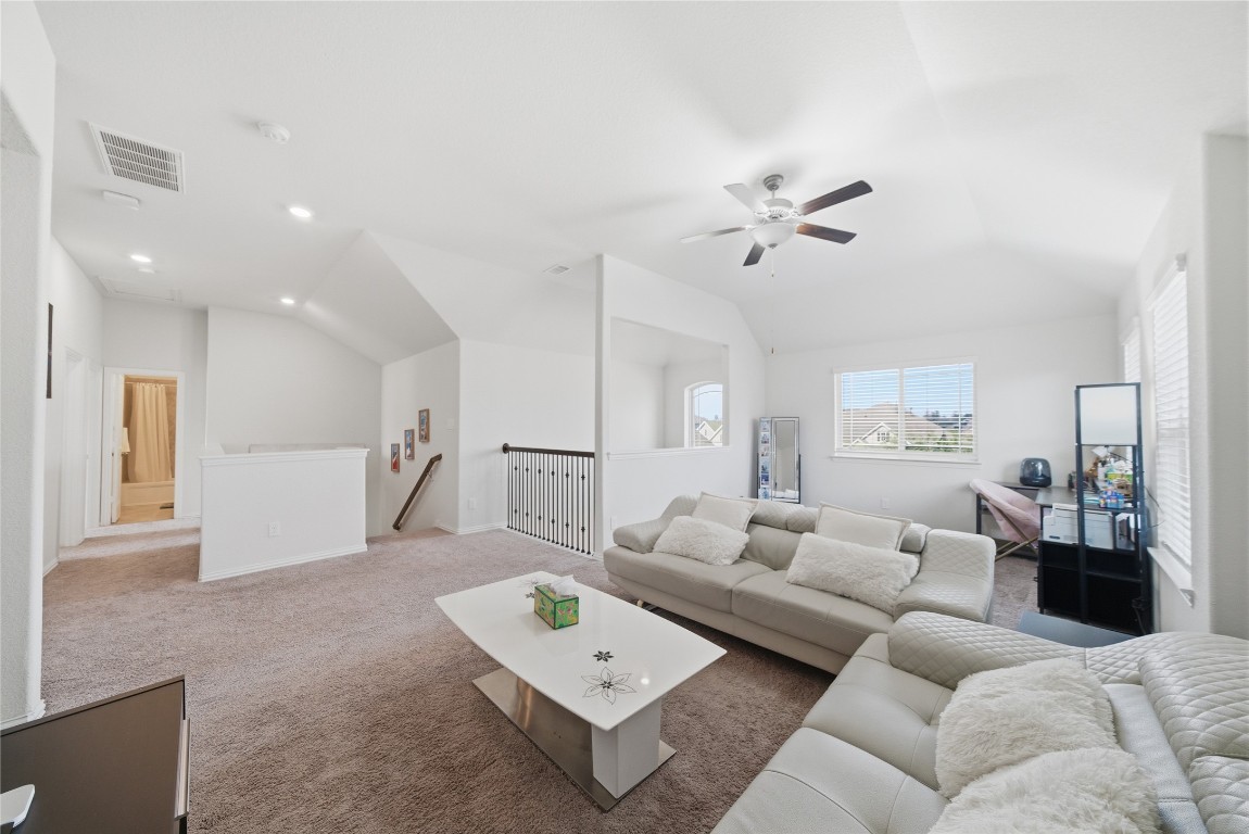 4335 Tawny Timber Drive Spring, TX 77386 - Photo 23 of 42 a living room with furniture a ceiling fan and a rug