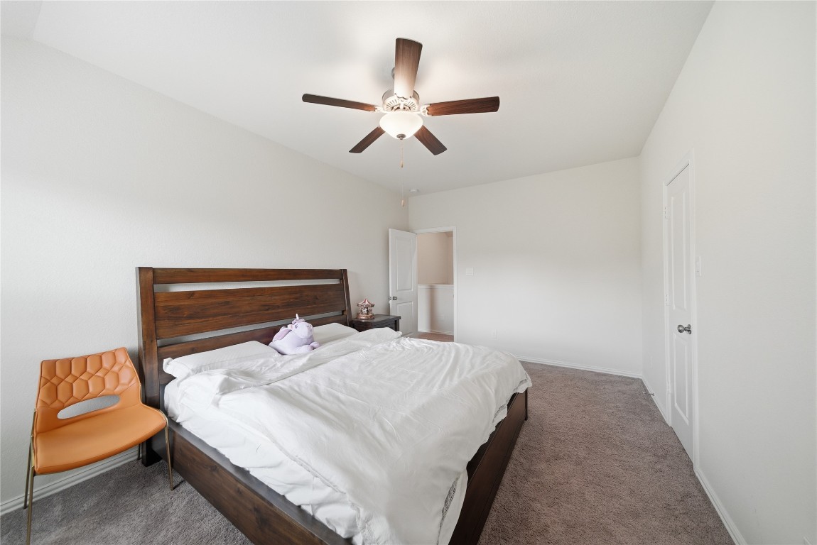 4335 Tawny Timber Drive Spring, TX 77386 - Photo 32 of 42 a bedroom with a bed and ceiling fan