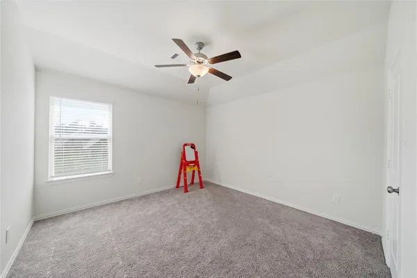 a bedroom with a bed and ceiling fan