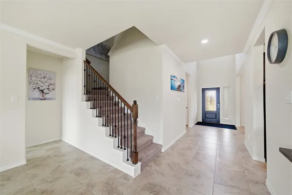 a view of a hallway with wooden floor and a living room