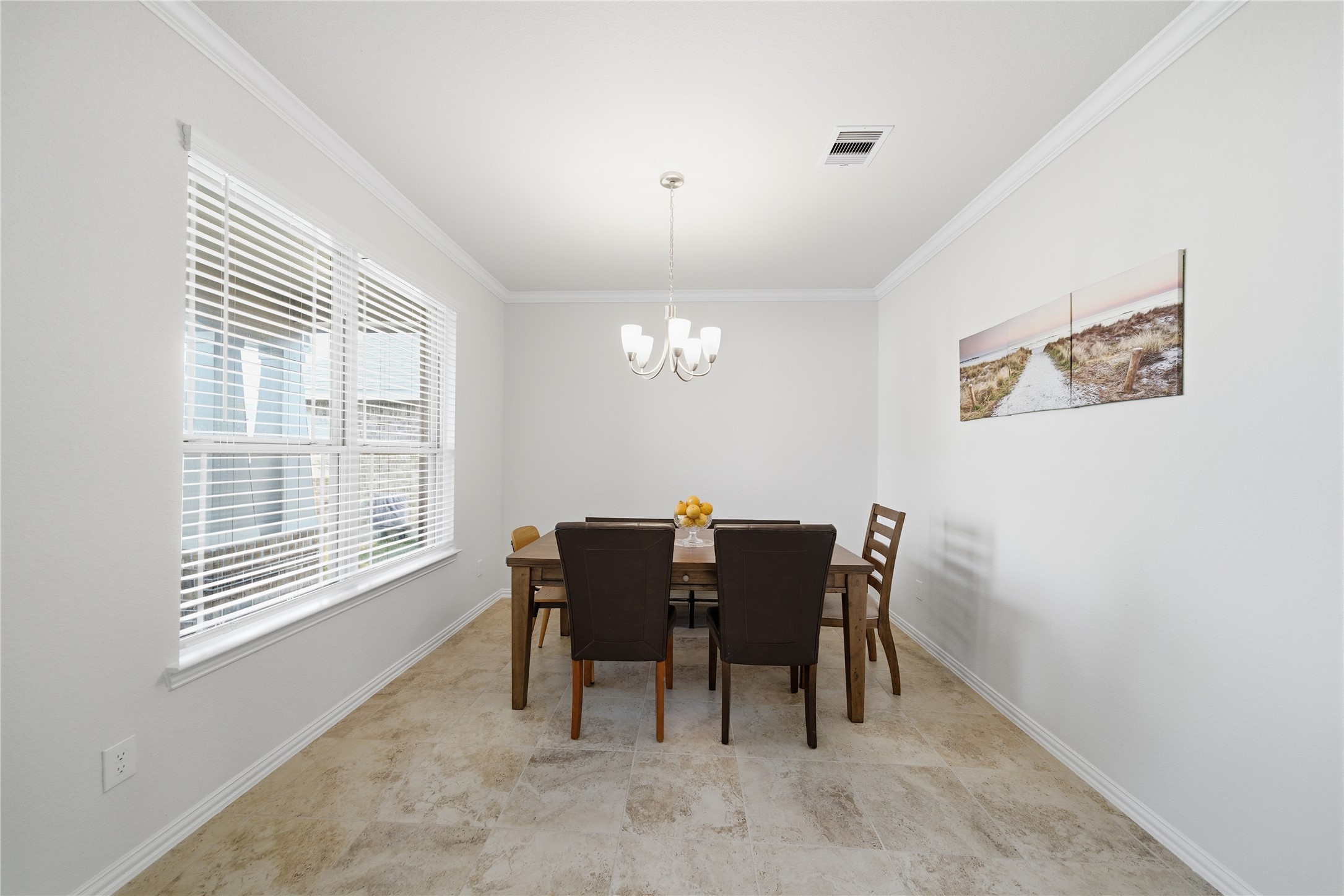 4335 Tawny Timber Drive Spring, TX 77386 - Photo 6 of 42 Bright dining room with large window, neutral walls, and tile flooring. Features a stylish chandelier and space for a six-person table.
