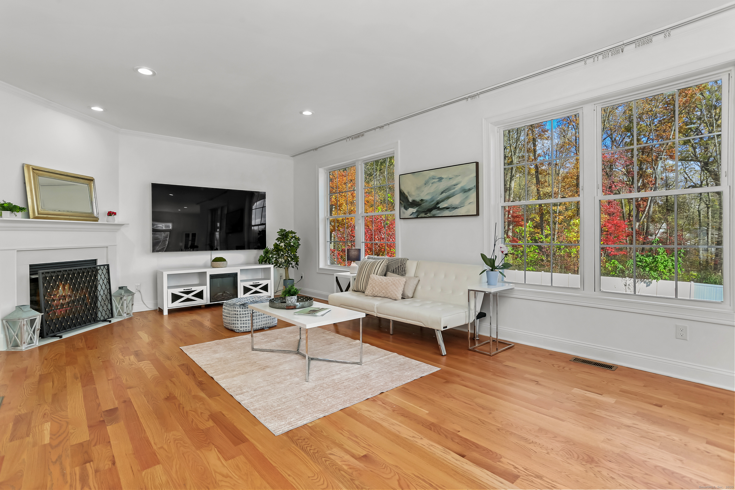 450 James Farm Road Stratford, CT 06614 - Photo 14 of 36 a living room with furniture a fireplace and a flat screen tv