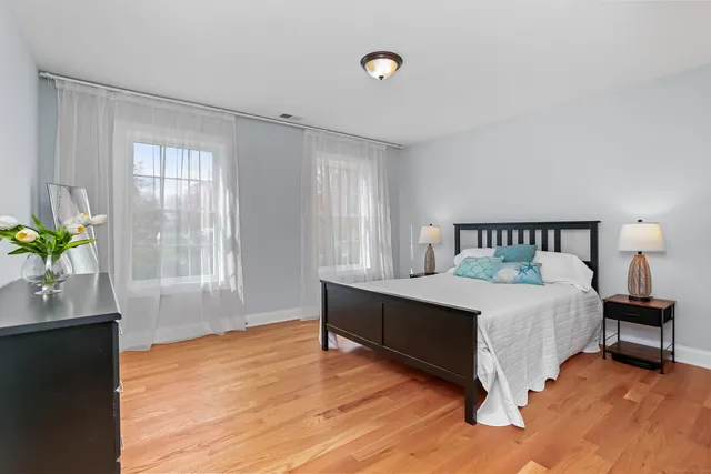 a spacious bedroom with a bed and a window