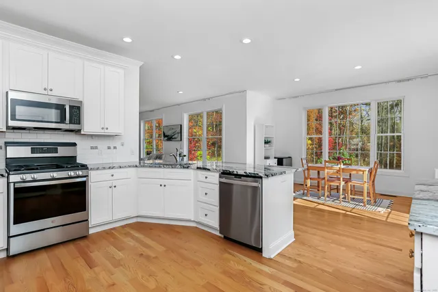 a kitchen with stainless steel appliances granite countertop a stove and a sink