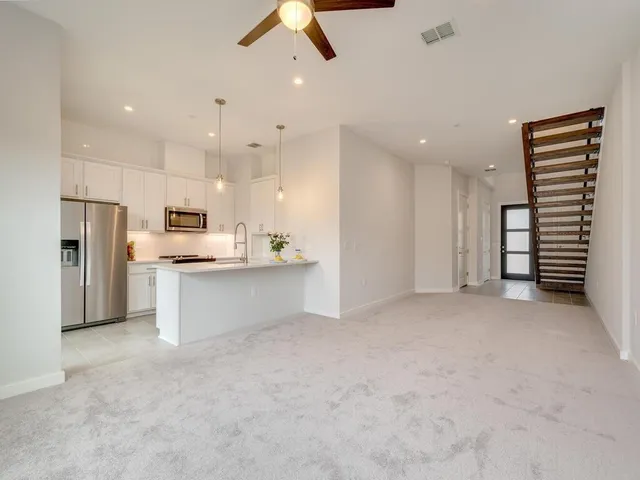 a view of kitchen appliances and cabinets