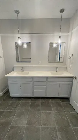 a bathroom with a sink a mirror and vanity