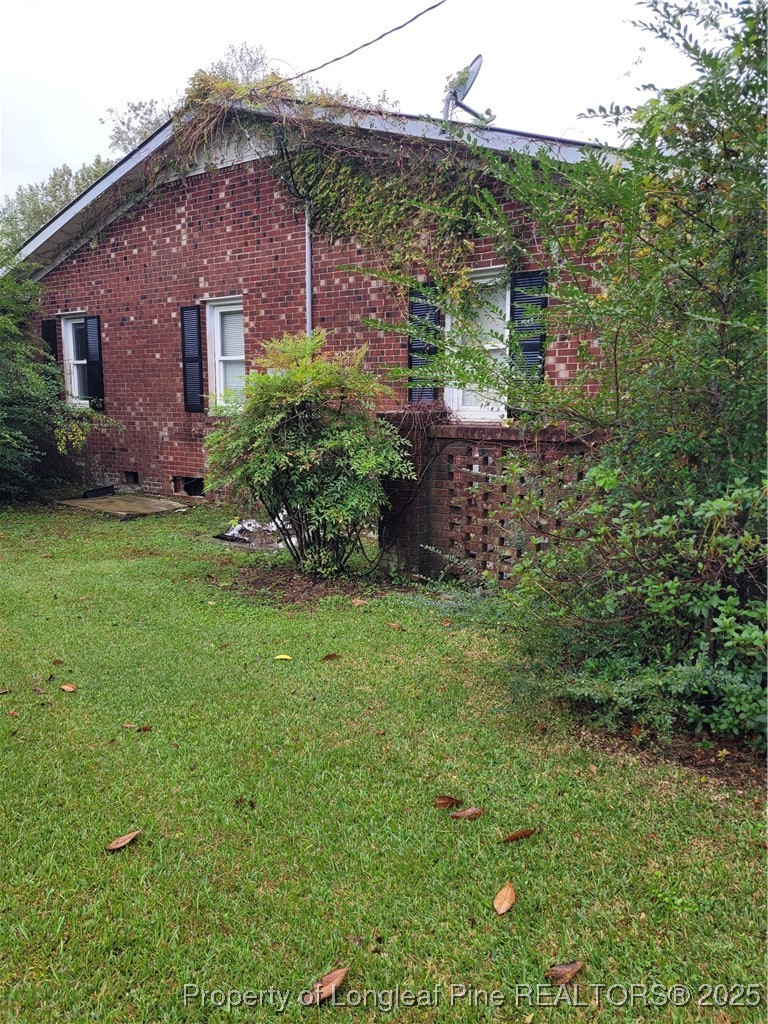 599 Haws Run Road Jacksonville, NC 28540 - Photo 11 of 43 a view of a brick house with a yard